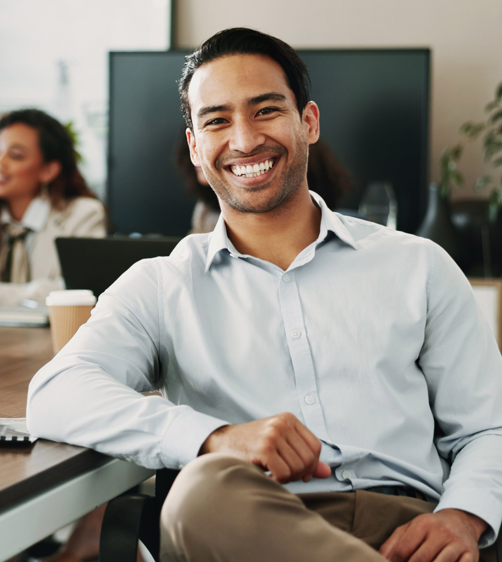 A man smiling at a boardroom table