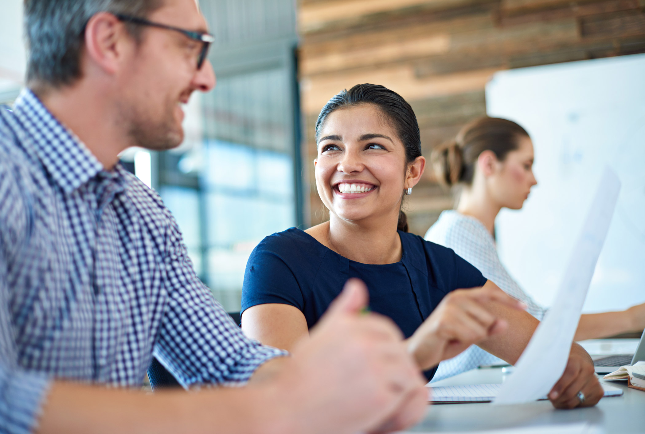 A mentee and mentor chatting at a desk
